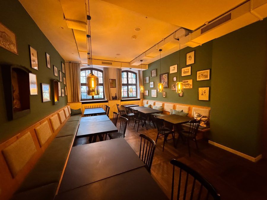 A long table under the lamps of the dining room