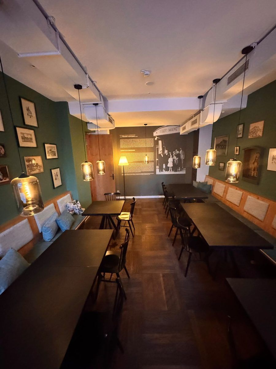 A view through the dining room to the wall with the historic photograph of the house