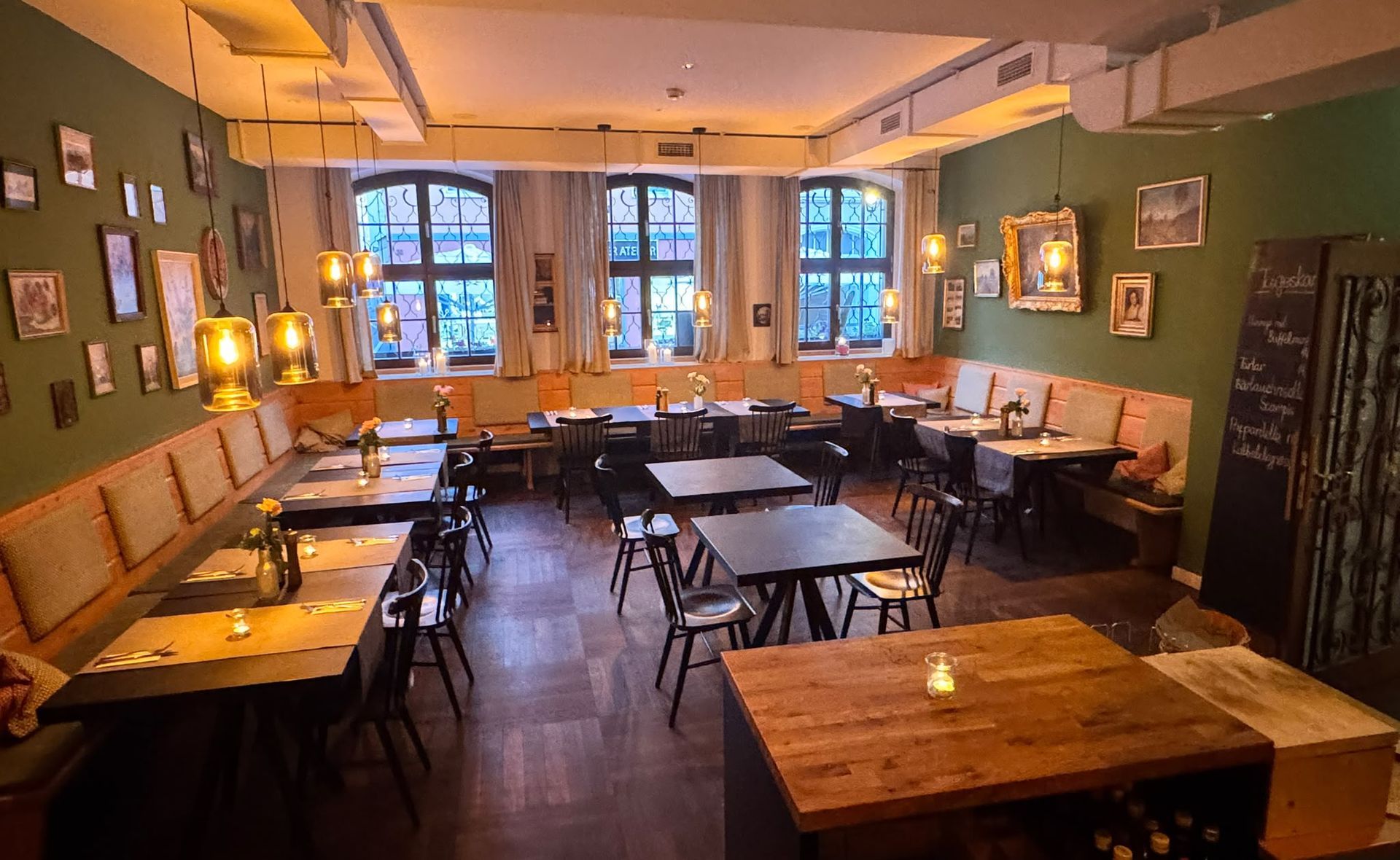The dining room in the evening, laid and lit by candles